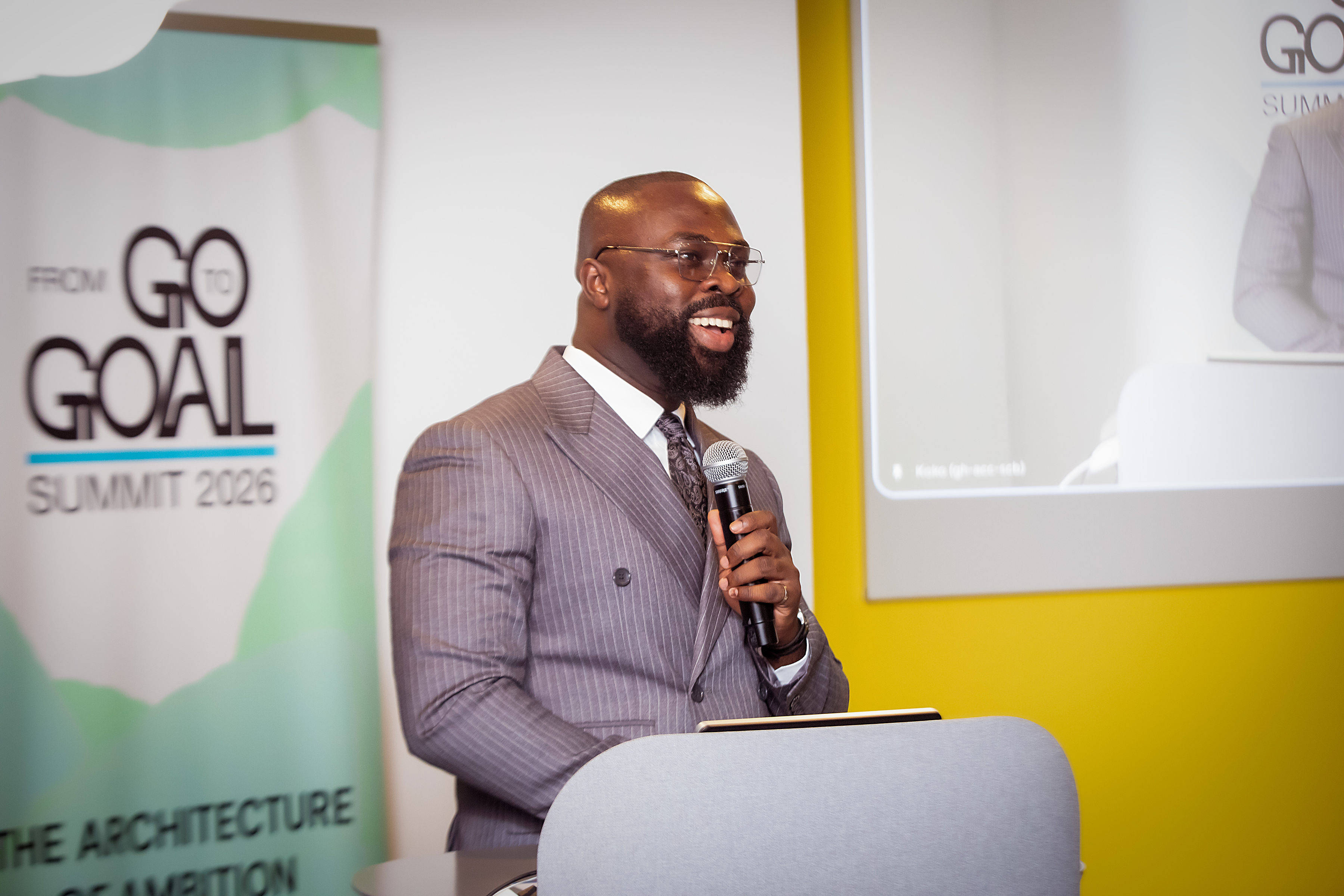 Alfred speaking on stage at the summit